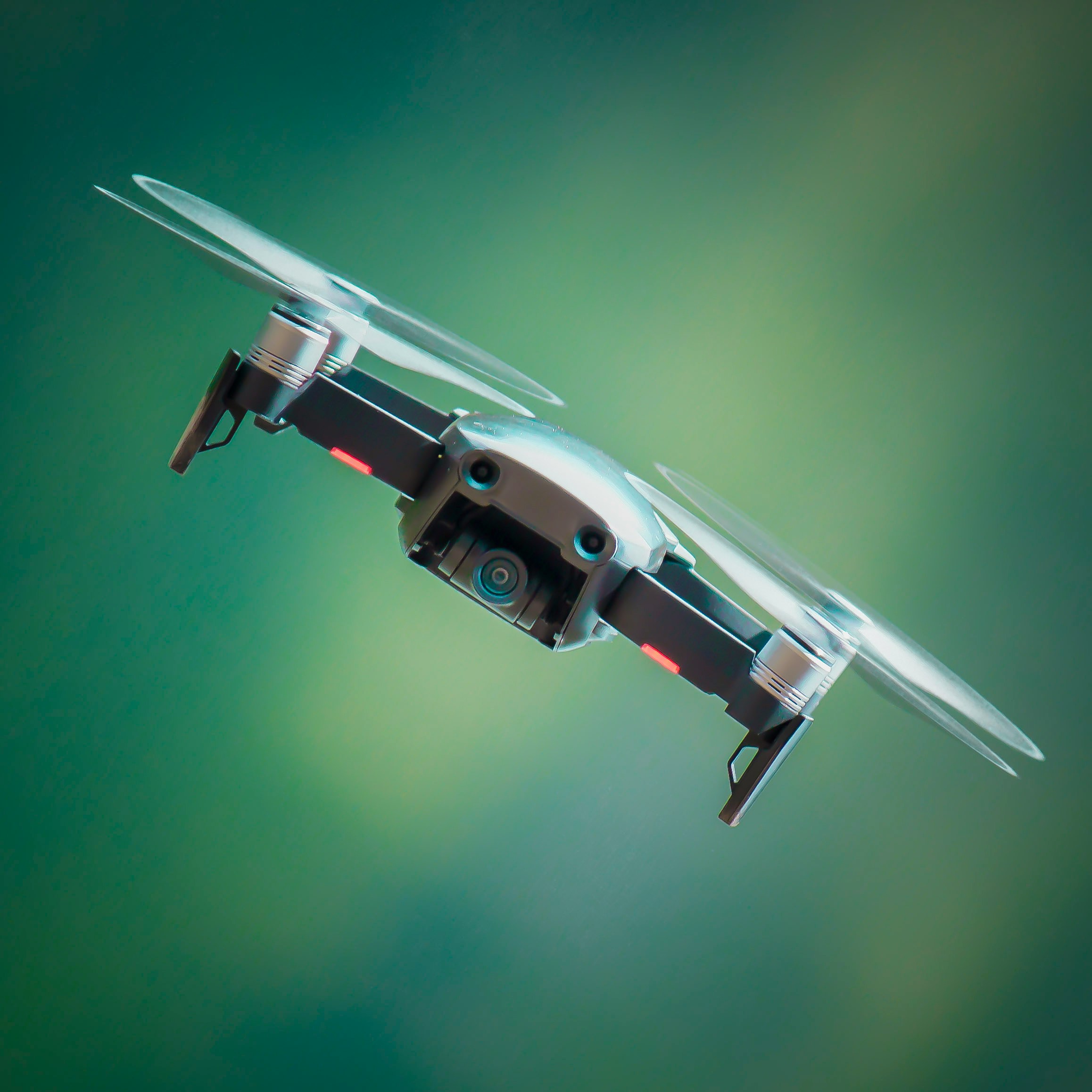 Custom-made drone flying over a modern cityscape at sunset